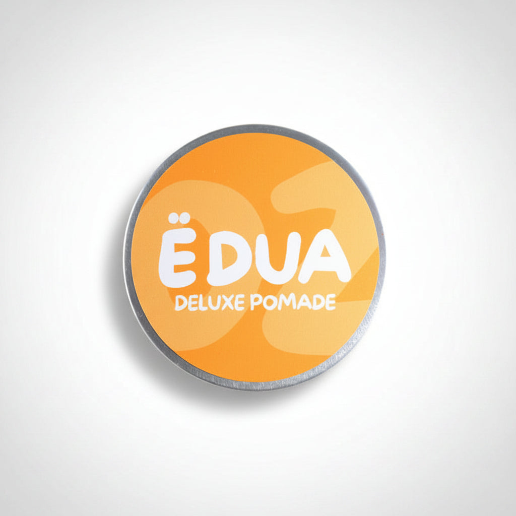 EDUA Deluxe Pomade container with orange label on a white background